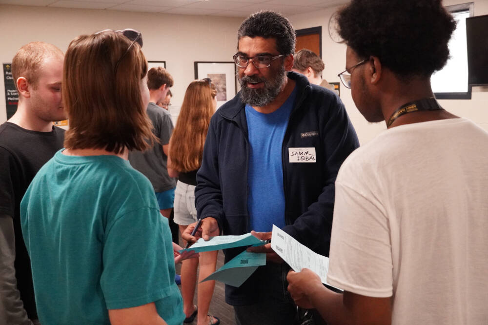 Samir Iqbal, associate dean and professor of computing, chats with students at the College of Computing welcome event.